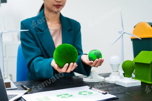 Preview: An Asian businesswoman sits at her desk, discussing clean energy solutions their impact on homes