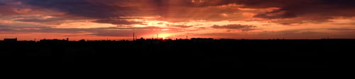 Preview: Panoramic view Red bright sunset over the city. City industrial landscape. The rays of the setting