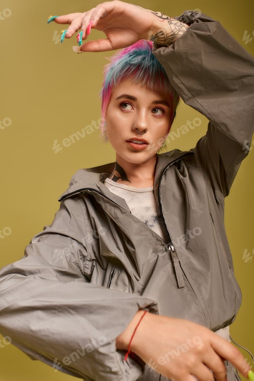 Preview: Colorful young woman expresses beauty and style in studio setting with unique hair