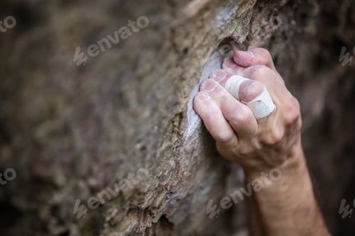 Preview: Closeup of rock climber's hand gripping hold