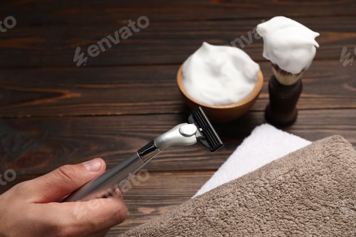 Preview: Barber with tools at wooden table, closeup. Space for text