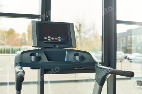 Preview: photo of black modern treadmill indoors in gym with window on backdrop, sport concept