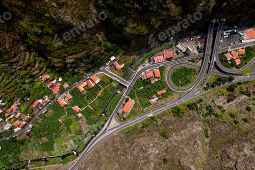 Preview: Red roofed houses located on hill slope at roadway in sunlight