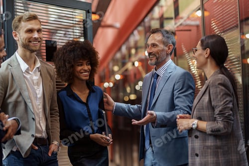 Preview: Multiethnic group of business people talking in office during break. Teamwork concept