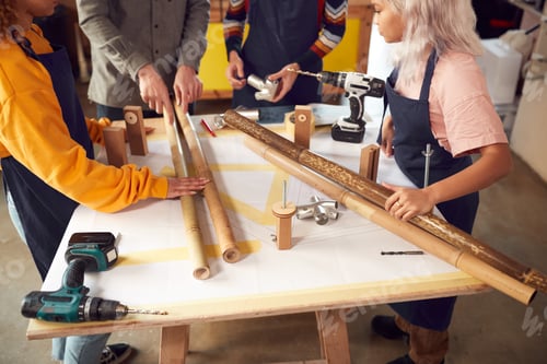 Preview: Close Up Of Team In Workshop Assembling Hand Built Sustainable Bamboo Bicycle Frame