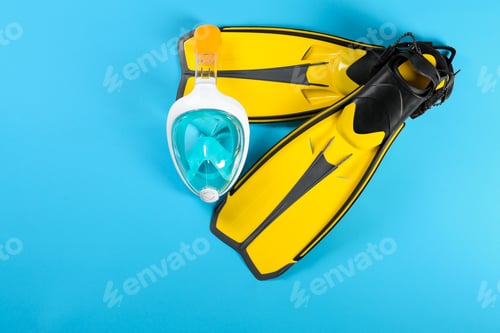Preview: Swimming flippers and mask on color background, top view. Space for text