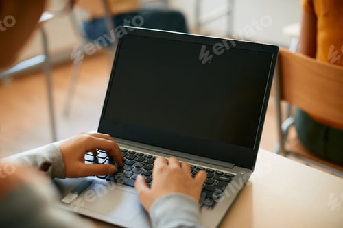 Preview: Close-up of student using laptop during computer class at high school.
