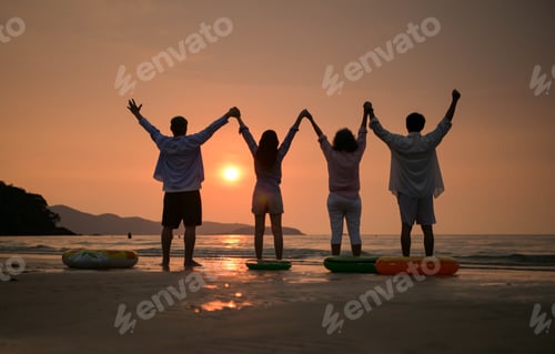 Preview: Back view of happy family holding hands on the beach at sunset, standing together