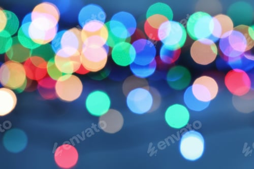 Preview: Blurred view of Christmas lights on color background