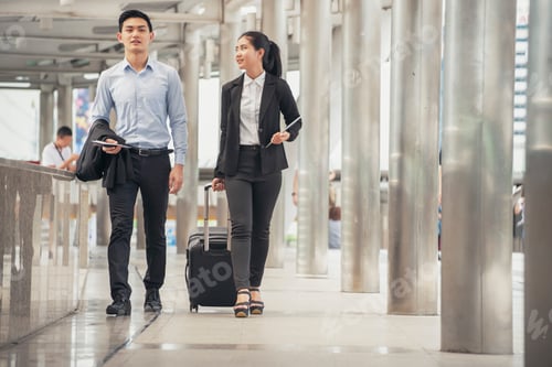 Preview: Business man and woman Dragging suitcase luggage bag, walking to passenger boarding in Airport.
