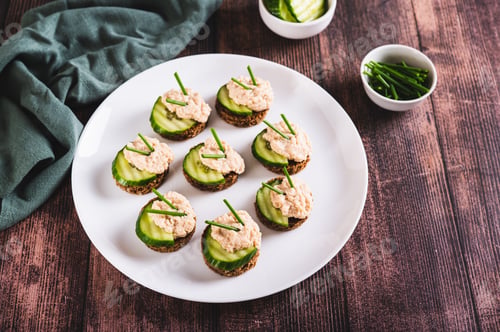 Preview: Appetizing sandwiches with pollock caviar, cucumber and herbs on a plate