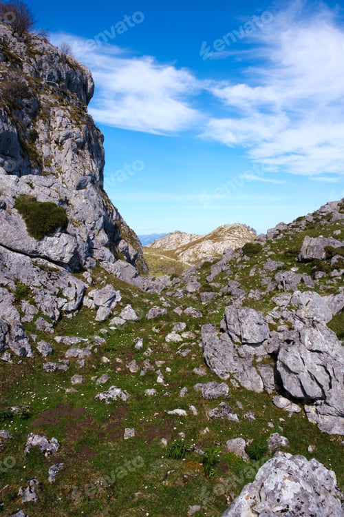 Preview: A rocky area with grass and rocks in the foreground, showcasing the rugged terrain of the Calcareous