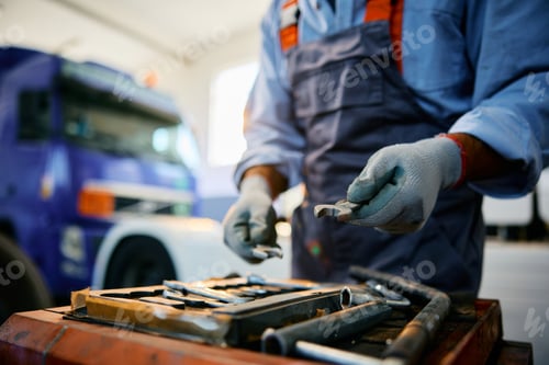 Preview: Close up of truck repair mechanic working in a garage.