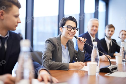 Preview: Smiling Young Businesswoman Speaking at Conference