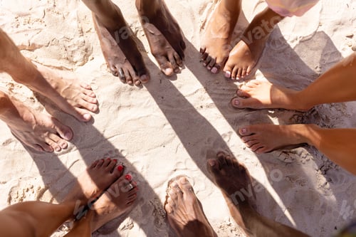 Preview: Close up of diverse friends feet at beach