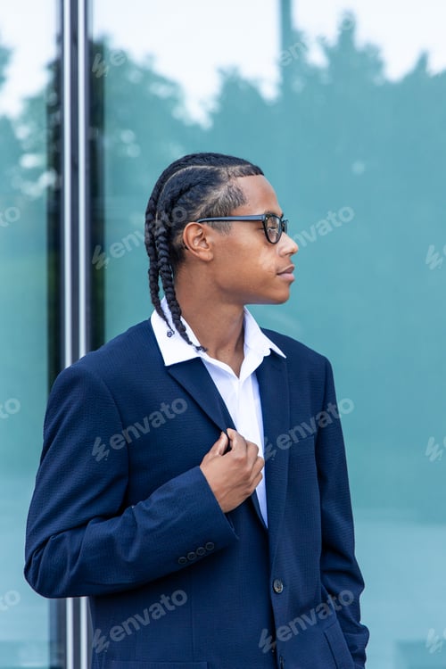 Preview: vertical Young multiethnic businessman adjusting his jacket looking away in the financial district