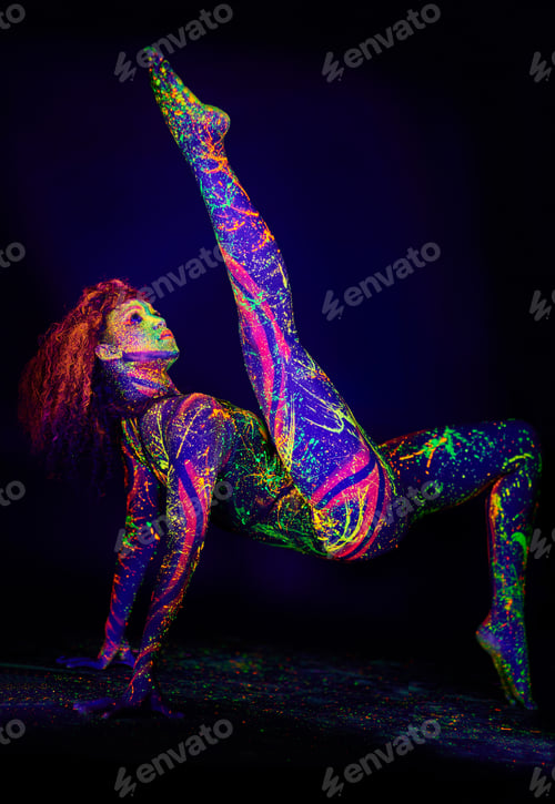 Preview: Treasures in the dark. Full length shot of a young woman posing with neon paint on her face.