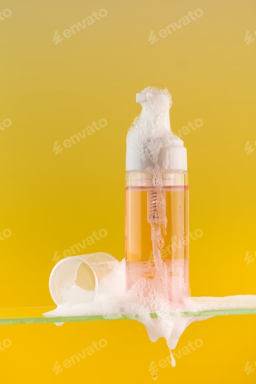 Preview: Dispenser mockup with face wash foam on a glass shelf on a yellow background. Acne remover.