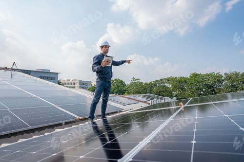 Engineer Inspecting Solar Panels on a Sunny Day