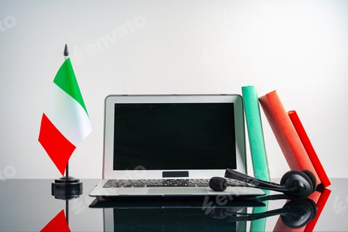 Preview: Laptop with Italy flag on working table, educational concept