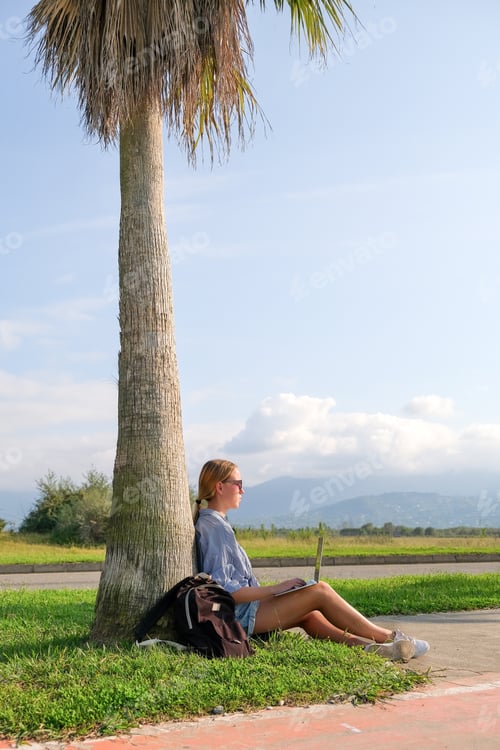 Preview: Remote work.Girl freelancer works remotely sea shore. workation,remote work,WFVH,Van Life vibes wor