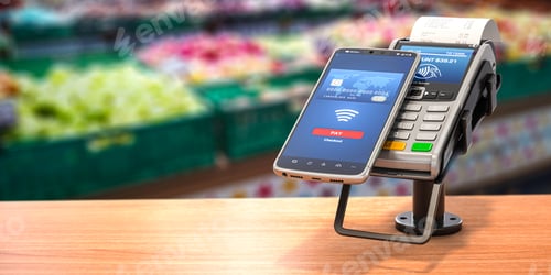 Preview: Contactless payment with smart phone. POS terminal with NFC mobile phone in asupermarket.