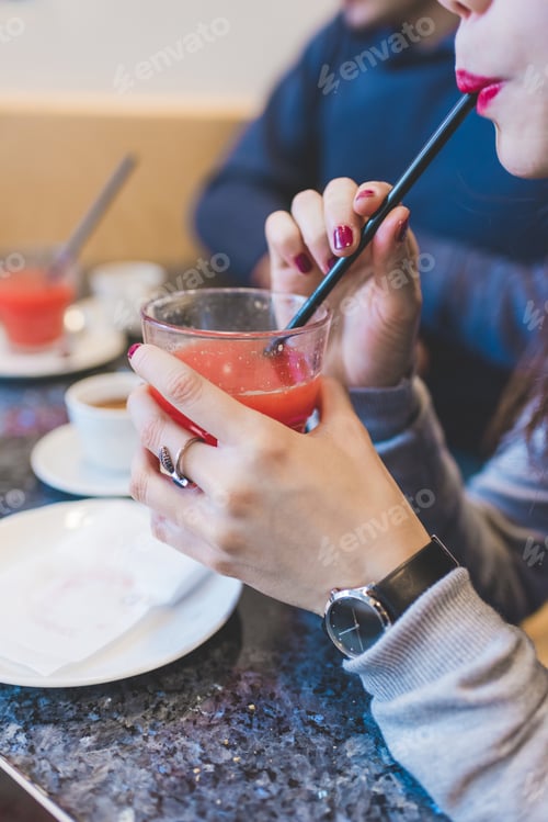 Preview: Close up woman sipping juice