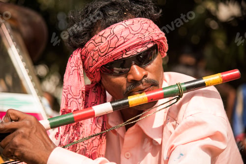 Preview: Tribal man perform music.