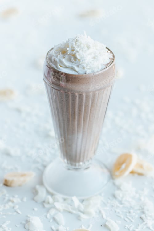 Preview: Vertical shot of a chocolate milkshake on the white background