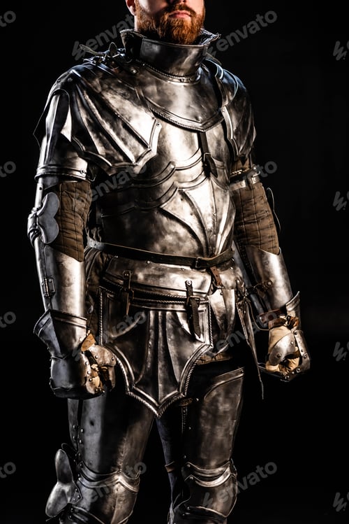Preview: cropped view of knight in armor isolated on black