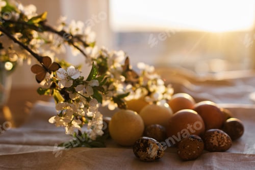 Preview: Blooming cherry branch with butterfly and modern easter eggs and on rustic cloth in sunny light