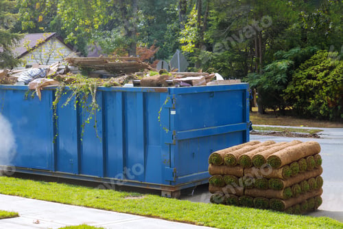 Preview: Lawn grass in rolls on pallets against of the street the rolled grass lawn ready for laying and