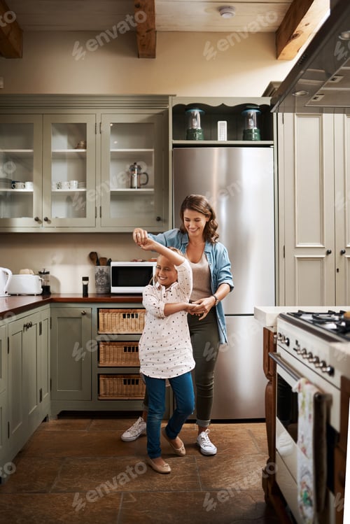 Preview: We know how to entertain ourselves. Shot of a young girl dancing at home with her mother.