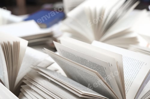 Preview: stack of books, close up. Open book on the table in library.