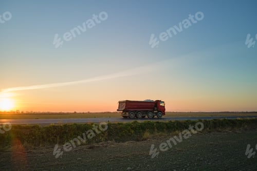 Preview: Aerial view of cargo truck driving on highway hauling goods.