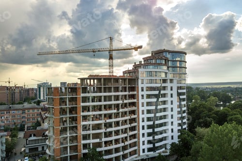 Preview: Apartment or office tall building under construction. Brick walls, glass windows, scaffolding and