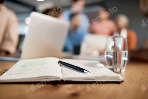 Preview: Let the up skilling begin. Shot of a notebook, pen and glass of water in a table at a conference.