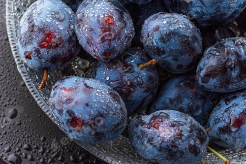 Preview: Wet Ripe Plums covered with water drops, closeup