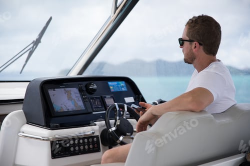 Man Navigating Yacht on a Tranquil Day