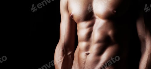 Preview: Masculinity in portrait. Studio shot of a muscular shirtless man isolated on black.