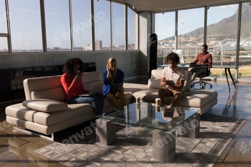 Preview: Front view of young multi-ethnic group of business people working together in the modern office