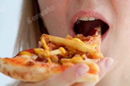 Preview: Closeup female mouth bites off a piece of pizza, food.