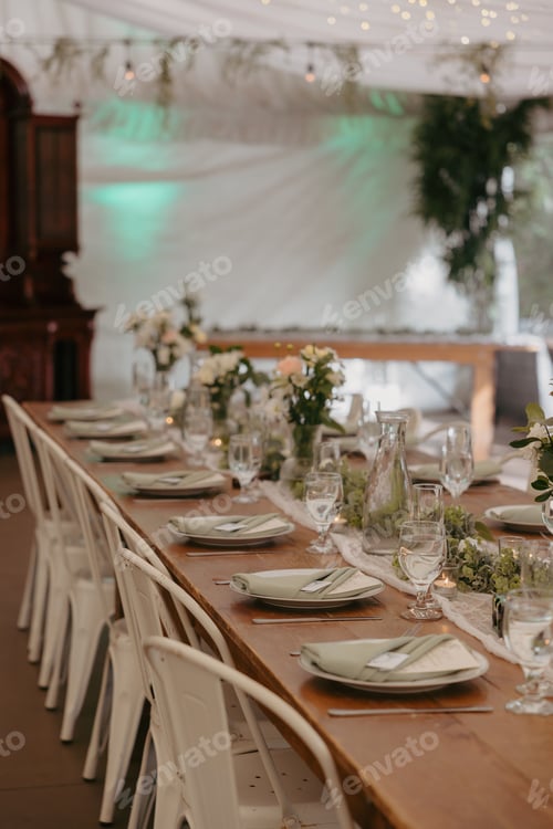 Preview: Elegant wedding table setting with flowers and glasses, perfect for a romantic celebration