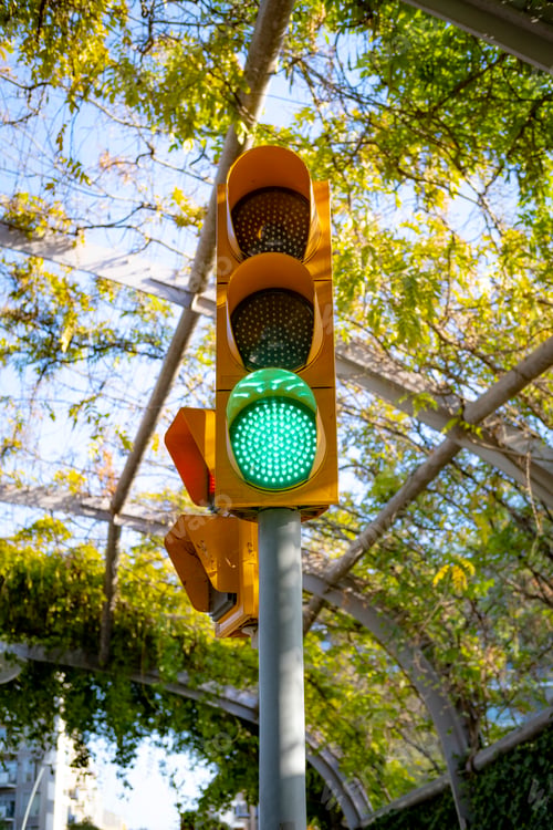 Preview: Vertical closeup shot of a greenlight on traffic lights in Barcelona, Catalonia, Spain