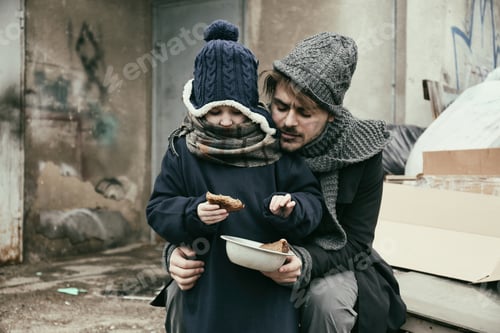 Preview: Poor father and child with bread at dump