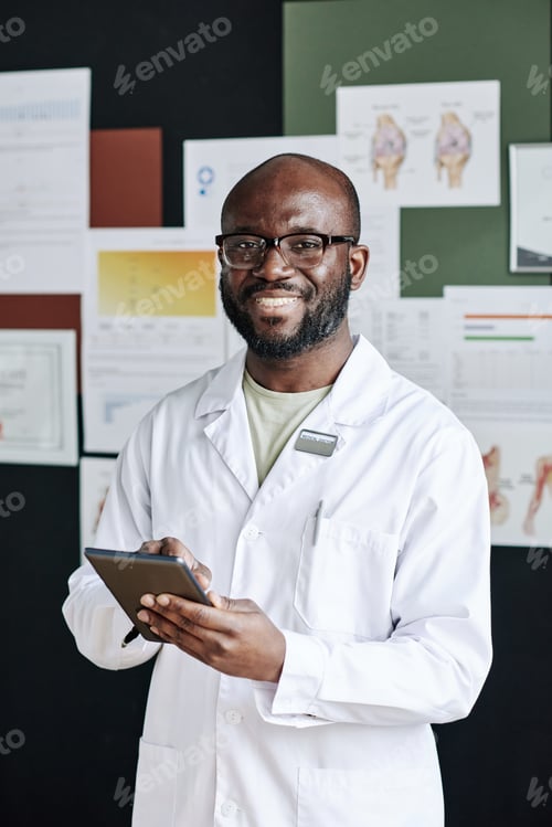 Preview: Successful male doctor using tablet pc