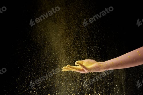 Preview: cropped view of woman holding yellow holi powder on black background