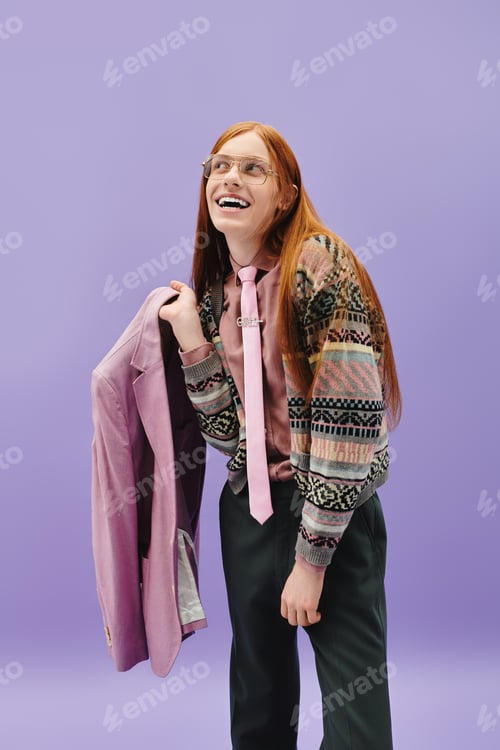 Preview: Young queer man showcases stylish outfit against a vibrant purple backdrop