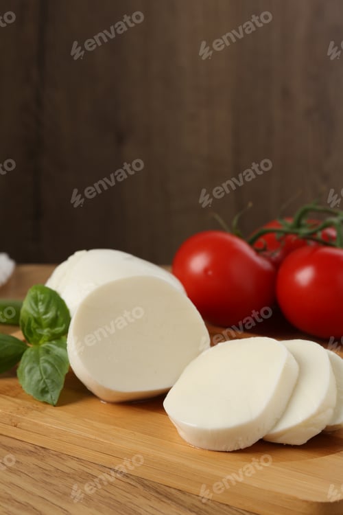 Preview: Tasty mozzarella, tomatoes and basil on wooden table, closeup
