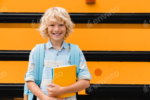 Preview: Small pupil smiling kid boy going back to school study education learning holding copybooks